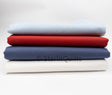 Stack of fabric swatches in blue, red, and white on a light gray background with 'Starlit Quilts' branding.
