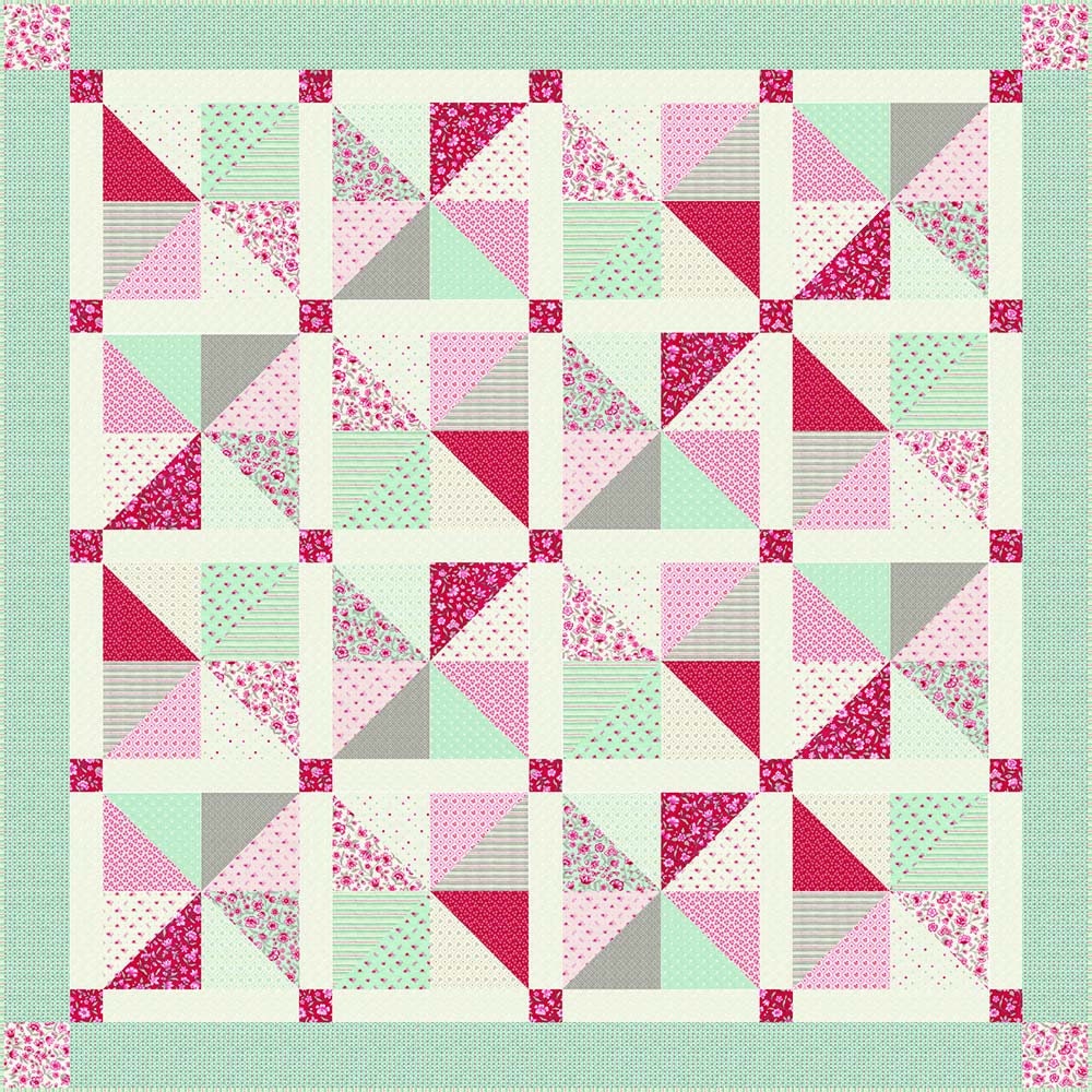 a pink and green quilt with triangles on it