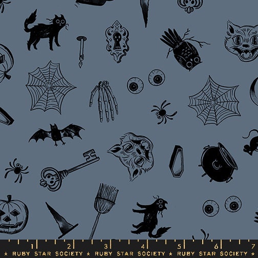 a black and white halloween themed pattern on a blue background