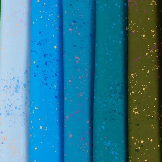 a row of different colored papers with gold and blue sprinkles