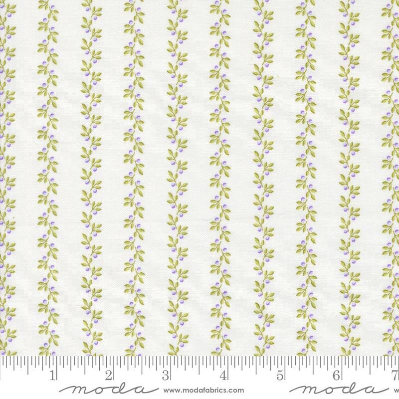 a white and green striped fabric with leaves on it