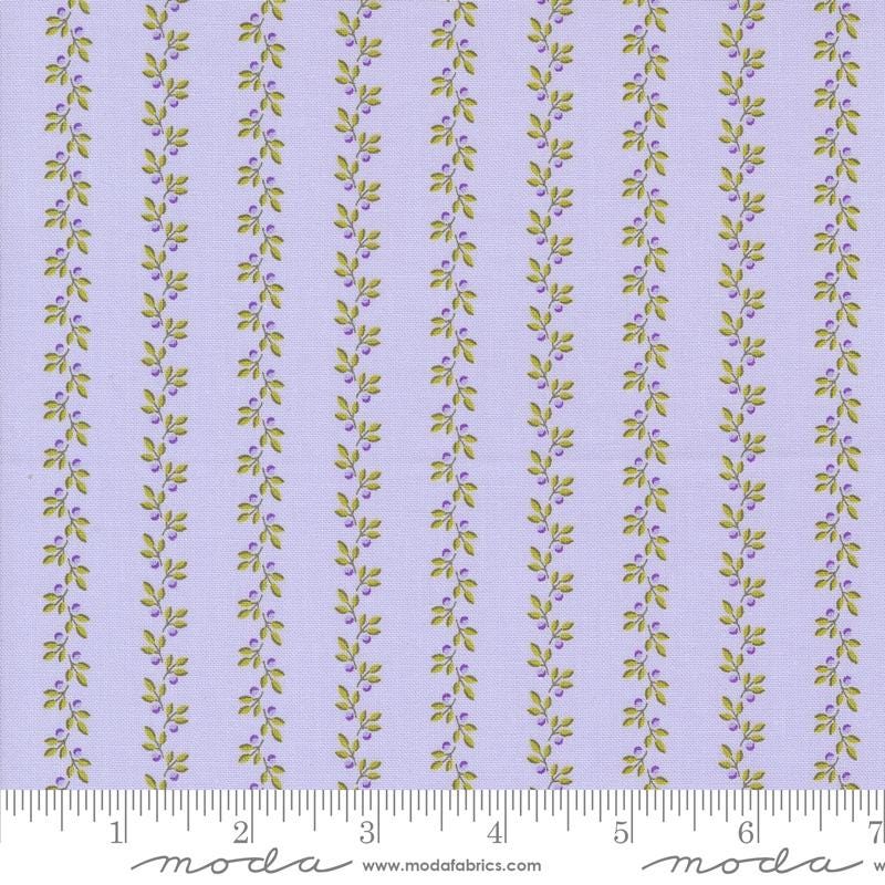 a purple and green striped fabric with leaves on it