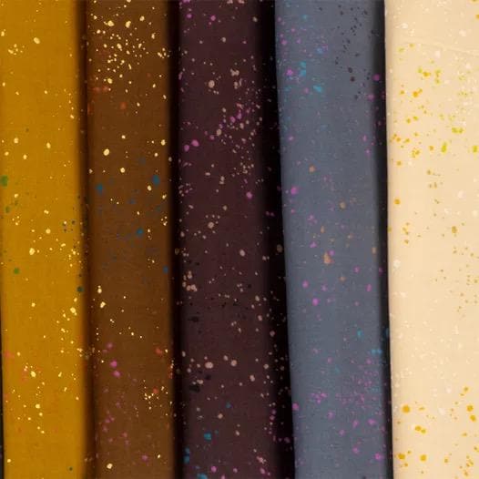 a row of different colors of paper with sprinkles