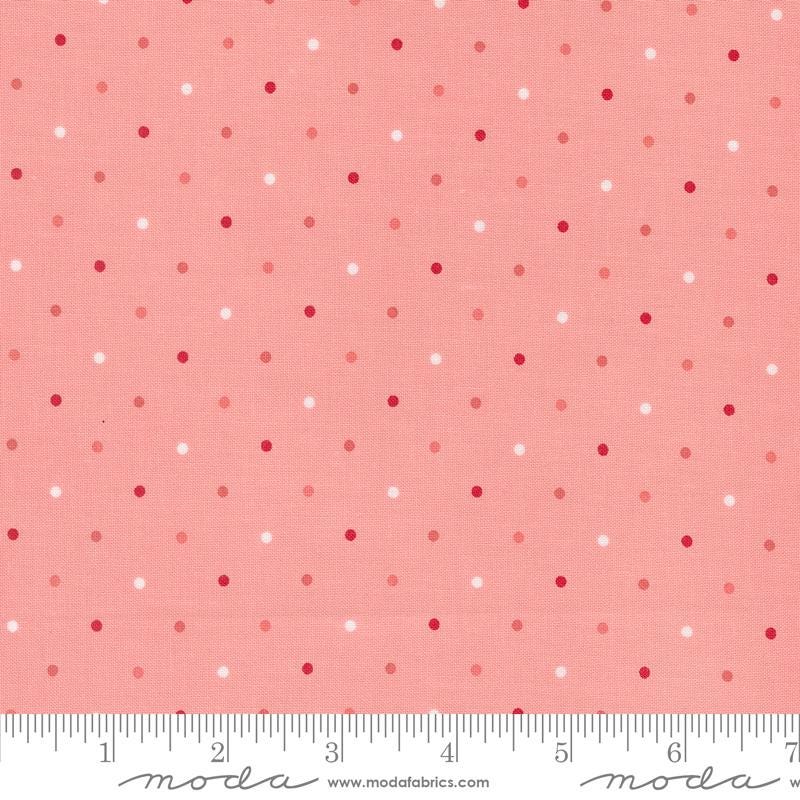 a pink and white polka dot print fabric