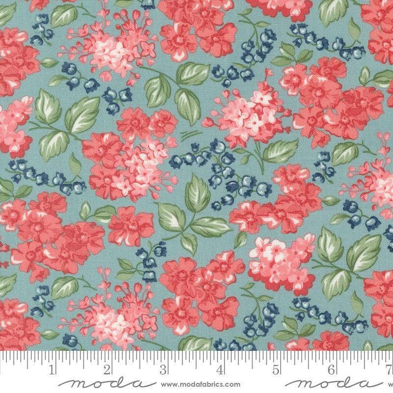 a blue and red flowered fabric with green leaves