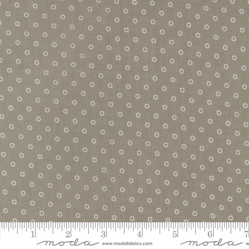 a ruler with a brown background with white circles