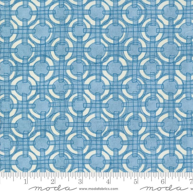 a blue and white fabric with circles on it