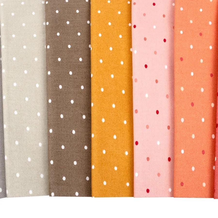 a row of different colored polka dot fabric