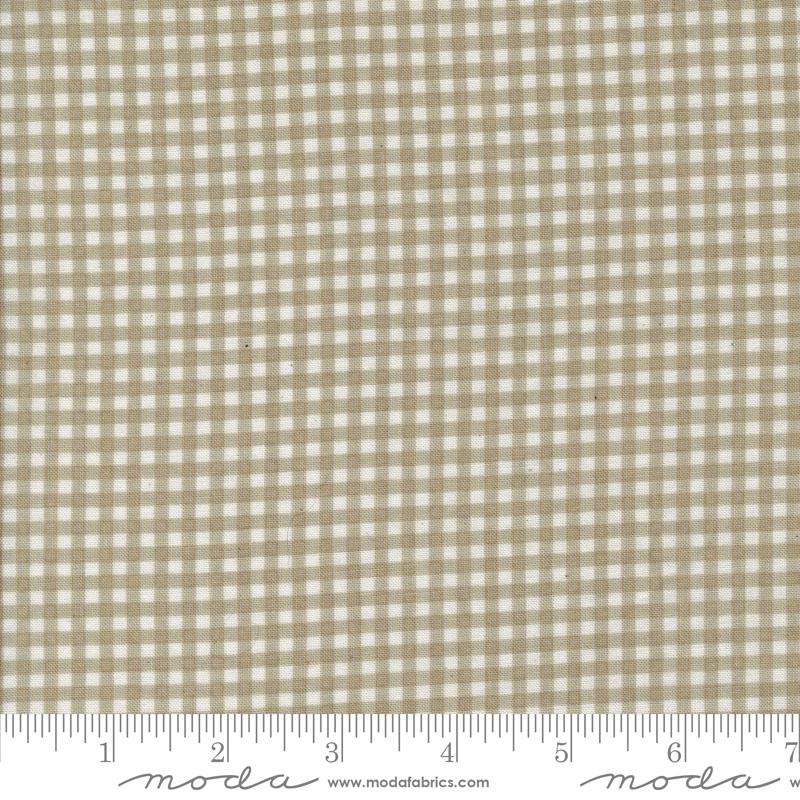 a beige and white checkered fabric with a ruler