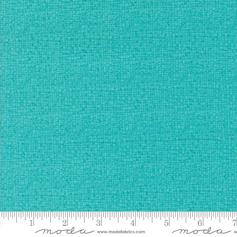 a ruler with a blue fabric on it