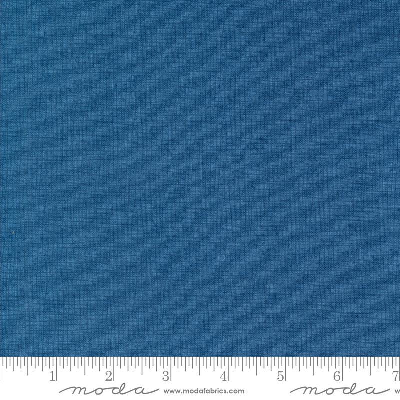 a blue fabric with a ruler in front of it