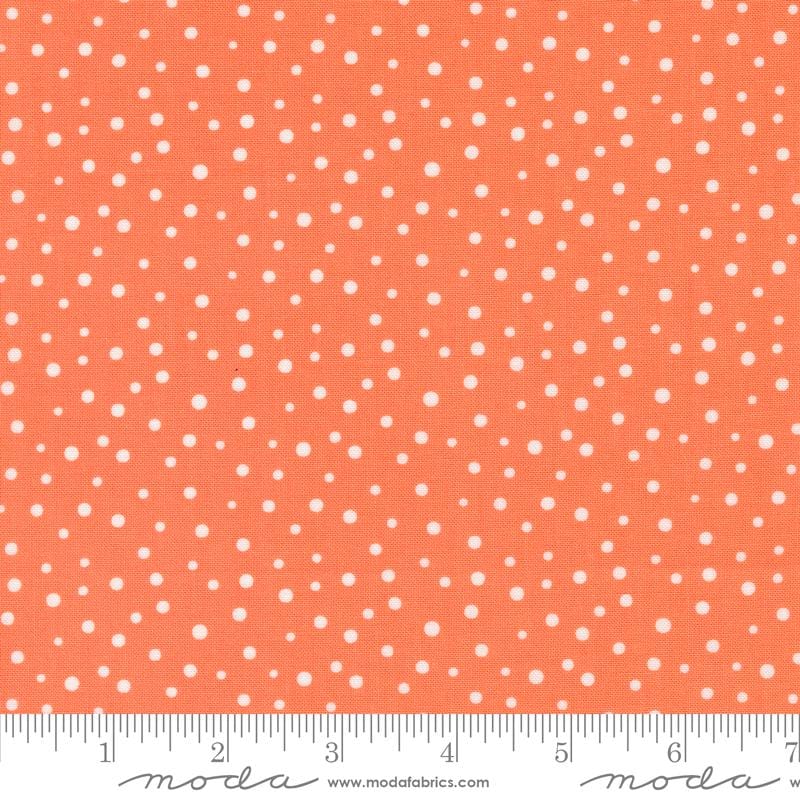 an orange and white polka dot print fabric