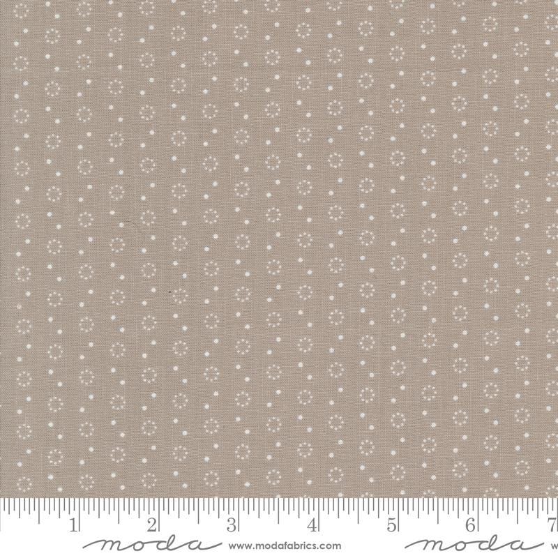 a ruler with a brown background with white dots