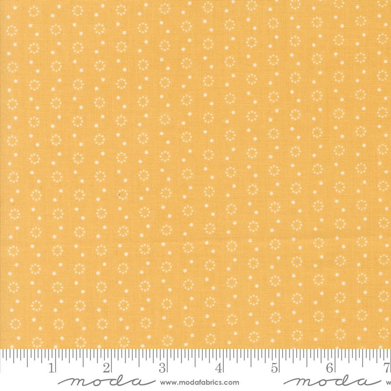 a yellow fabric with white dots on it