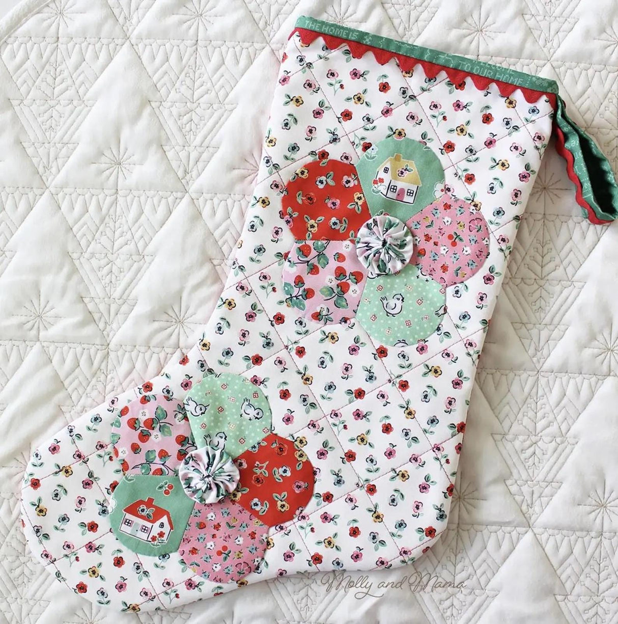 a close up of an oven mitt on a quilt