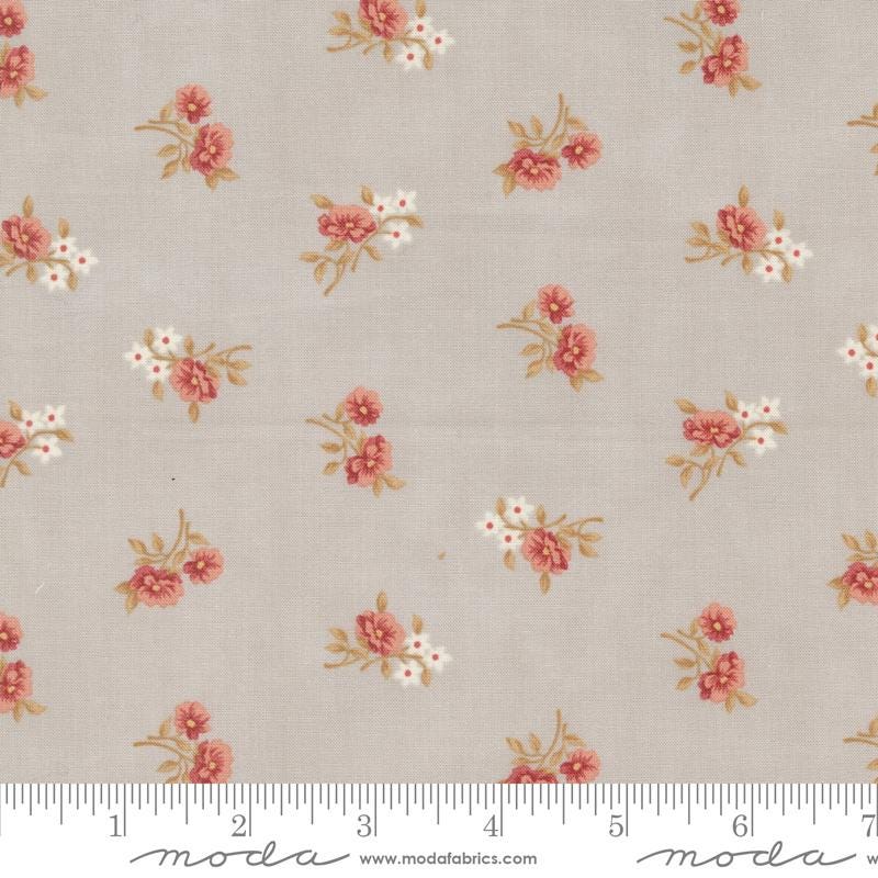 a white and pink flowered fabric with a ruler in front of it