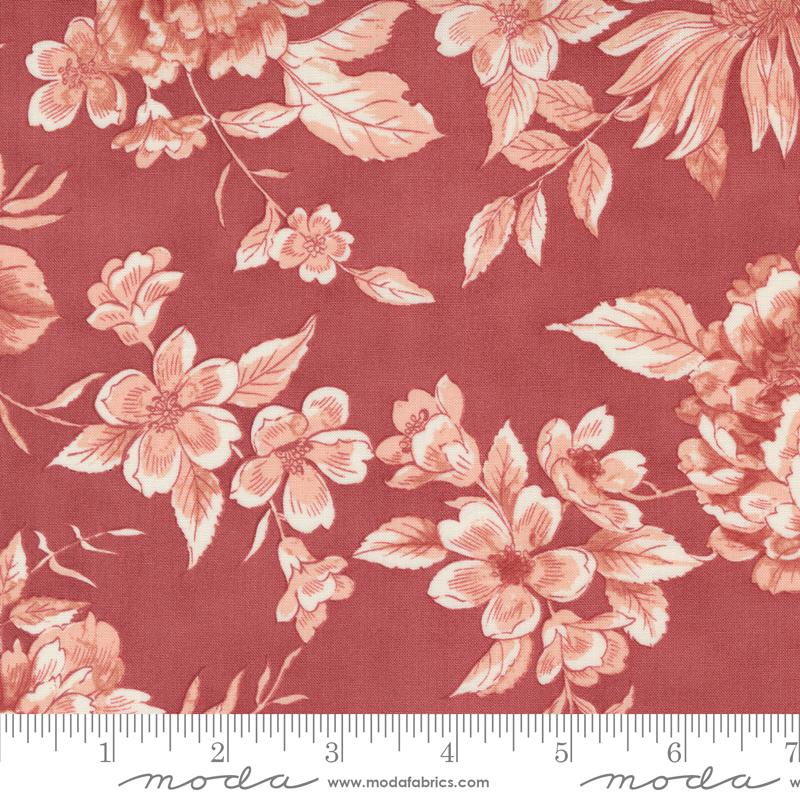 a red flowered fabric with a ruler in front of it