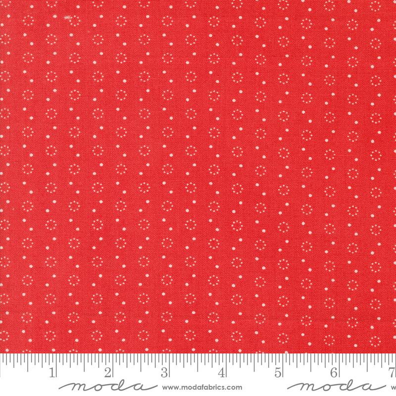 a red fabric with white dots on it