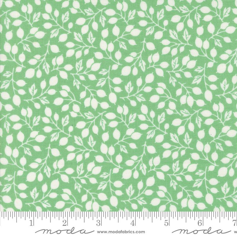 a green and white fabric with leaves on it