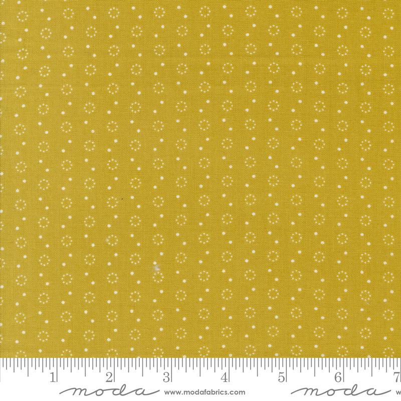 a yellow fabric with white dots on it