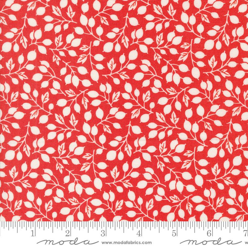 a red fabric with white leaves on it