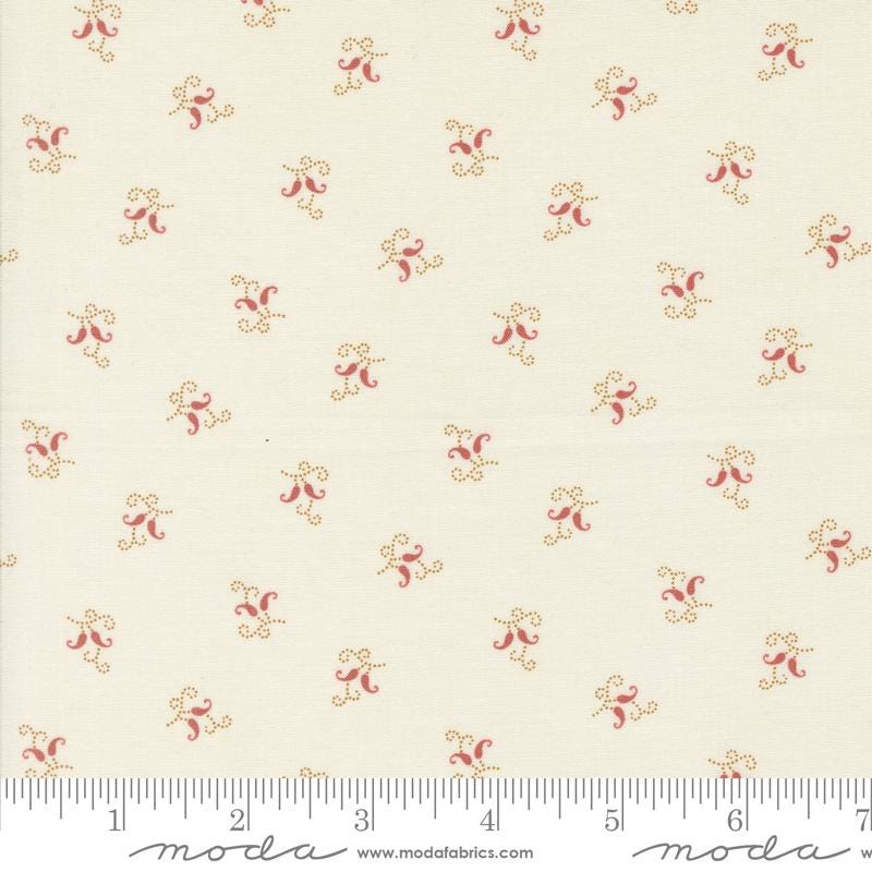 a close up of a white fabric with red flowers on it