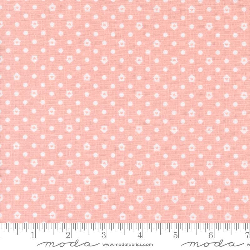 a pink fabric with white dots on it