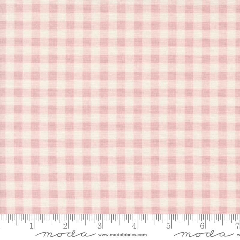 a pink and white checkered fabric with a ruler