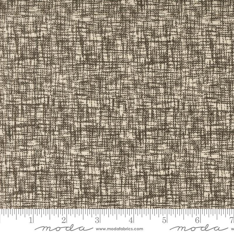 a brown and white textured fabric with a ruler