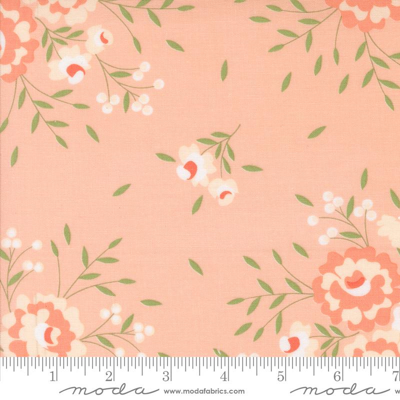 a pink flowered fabric with green leaves and flowers