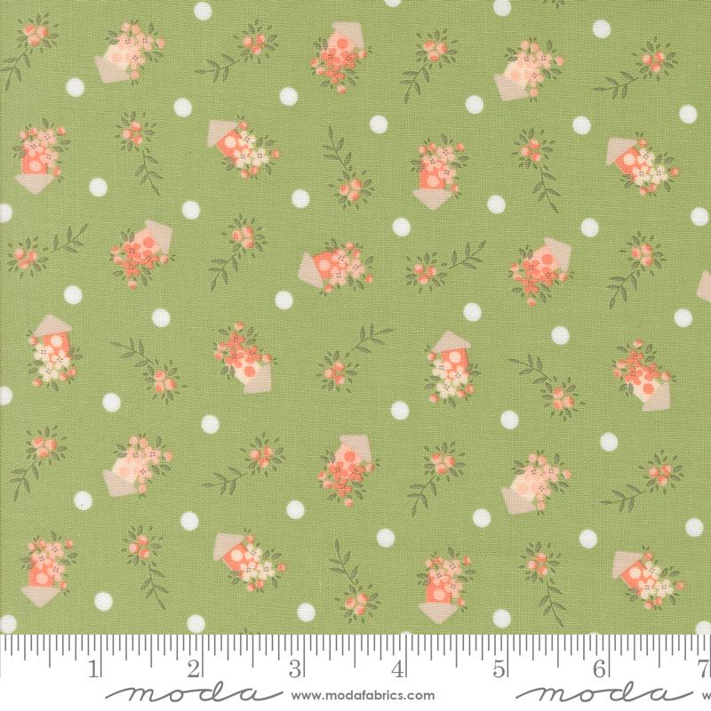 a green background with pink flowers and polka dots