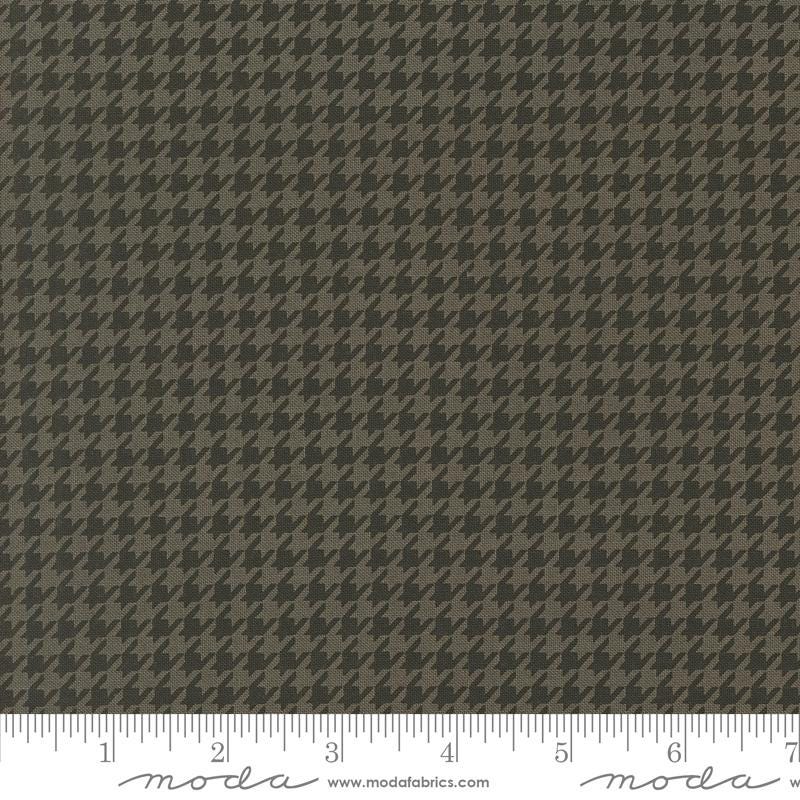 a brown and black checkered fabric with a ruler