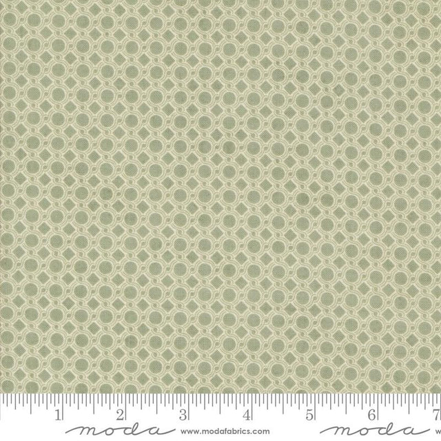 a repeating pattern of green circles on a fabric surface.