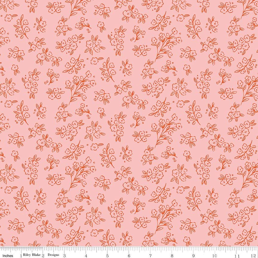 a repeating pattern of small orange flowers and leaves on a pink background.