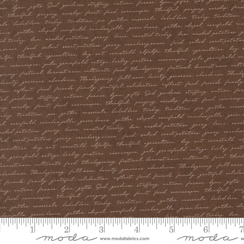 a brown fabric with a repeating pattern of cursive text, which appears to be a printed design. The text is not uniform and varies in size and style, creating a visually interesting and textured appearance.