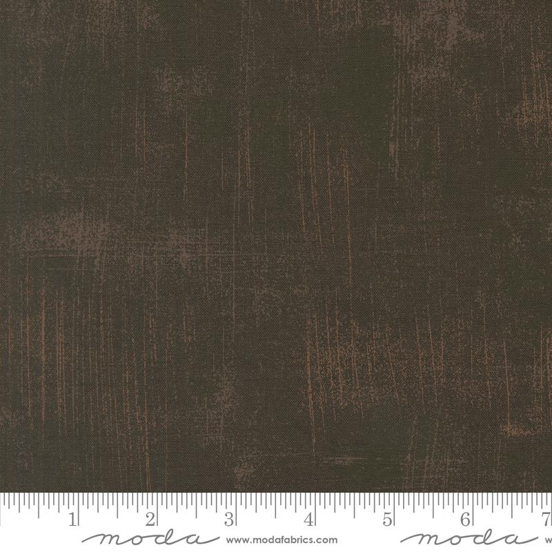 The image is a close-up of a textured fabric with a dark brown or black color.