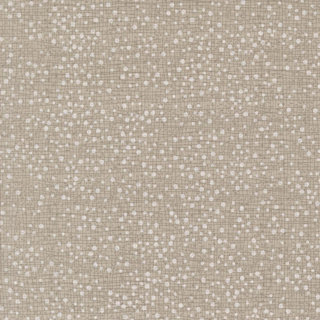 The image is a close-up of a textured fabric with small white dots or dots scattered across it, creating a speckled or speckled appearance.