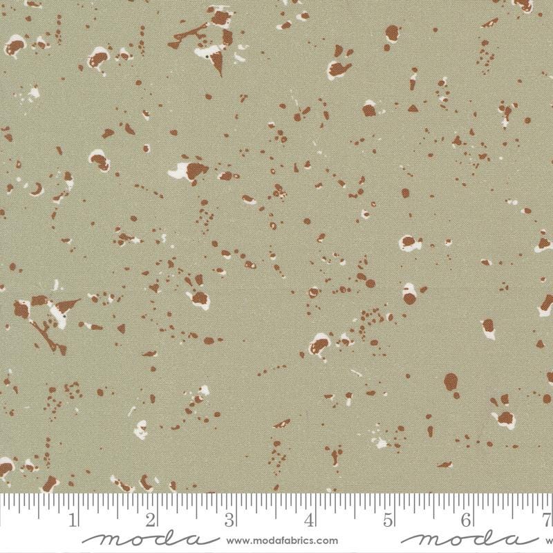 The image is a fabric with a speckled pattern in shades of brown and beige.