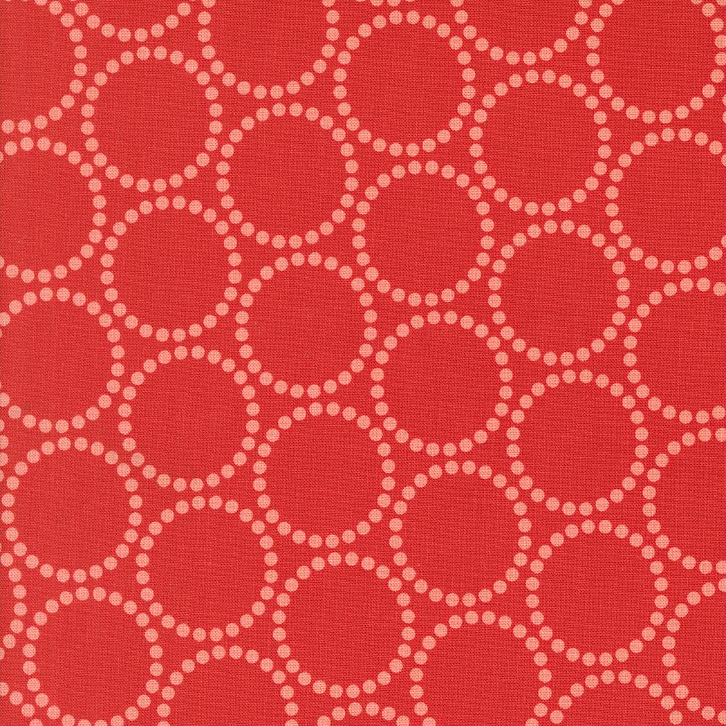 a repeating pattern of red circles with white dots on a red background.