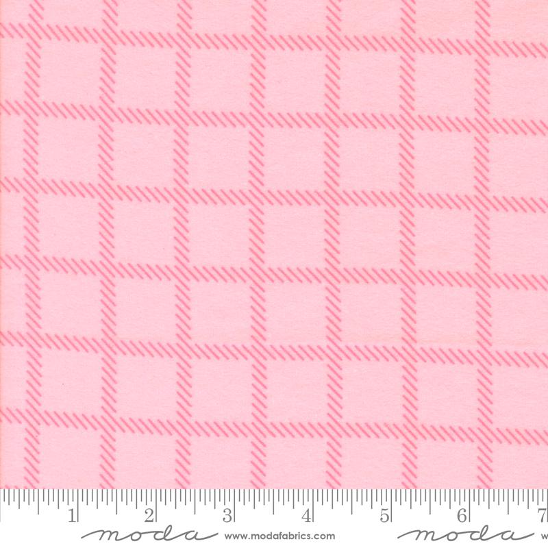 a pink fabric with a repeating pattern of pink squares and thin pink lines, creating a checkered or plaid design.