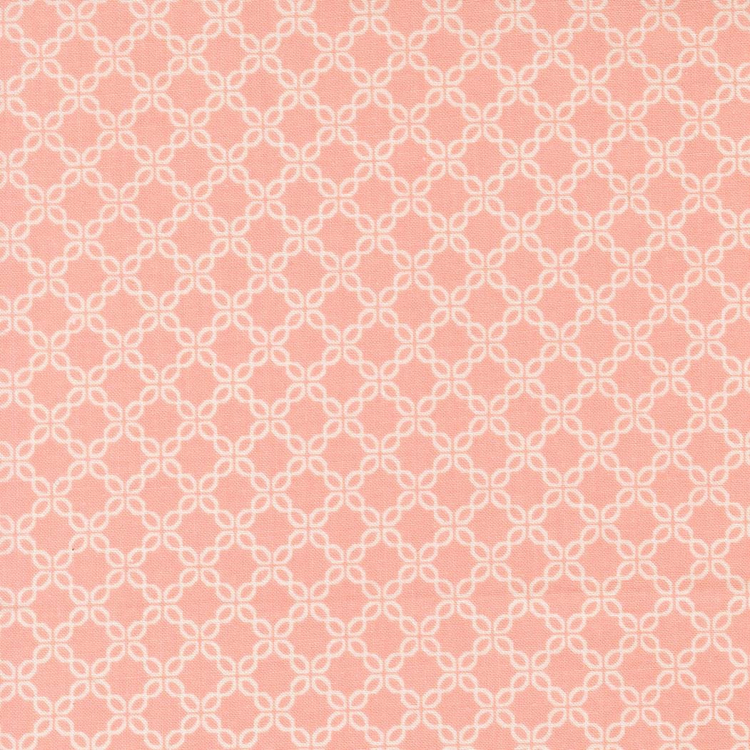 a repeating pattern of white flowers on a pink background.