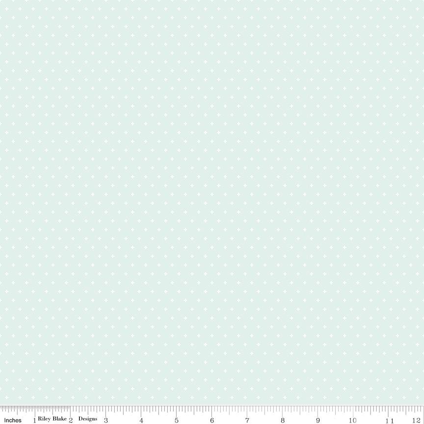 The image is a light blue fabric with small white polka dots covering the entire surface.