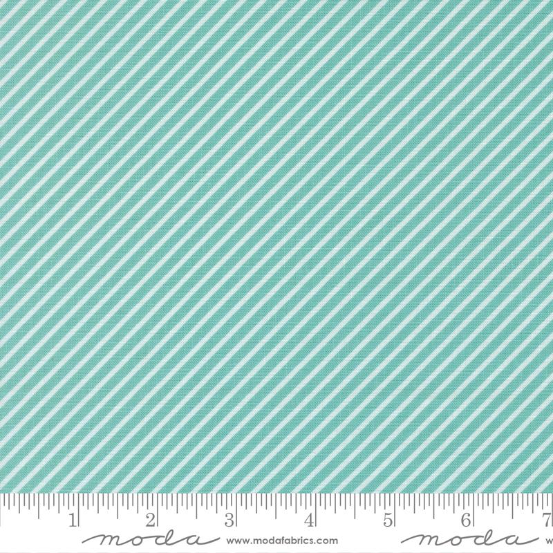 a fabric with a diagonal striped pattern in shades of green and white. The fabric appears to be a textile or material with a repeating diagonal pattern.