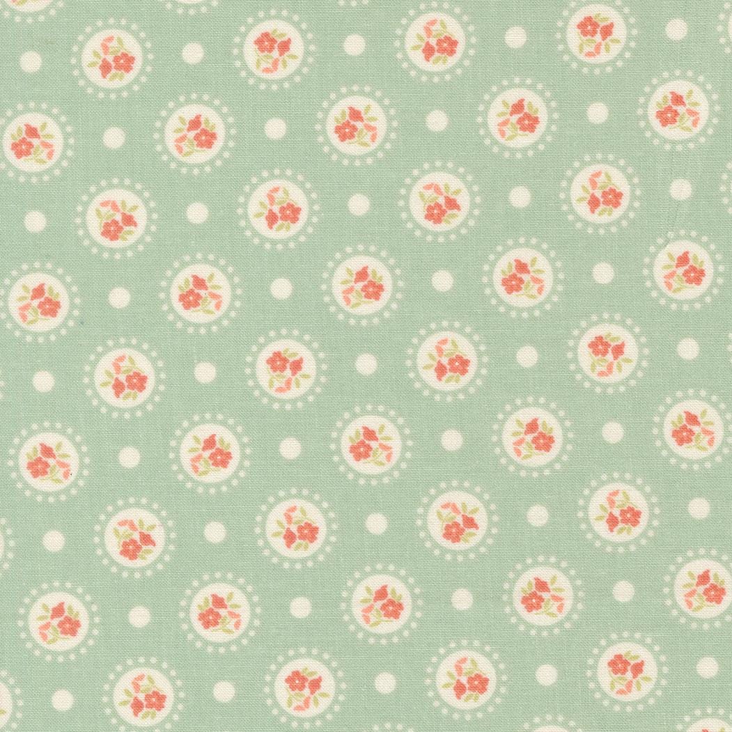 a repeating pattern of circular floral designs on a light green background, with white polka dots scattered throughout.