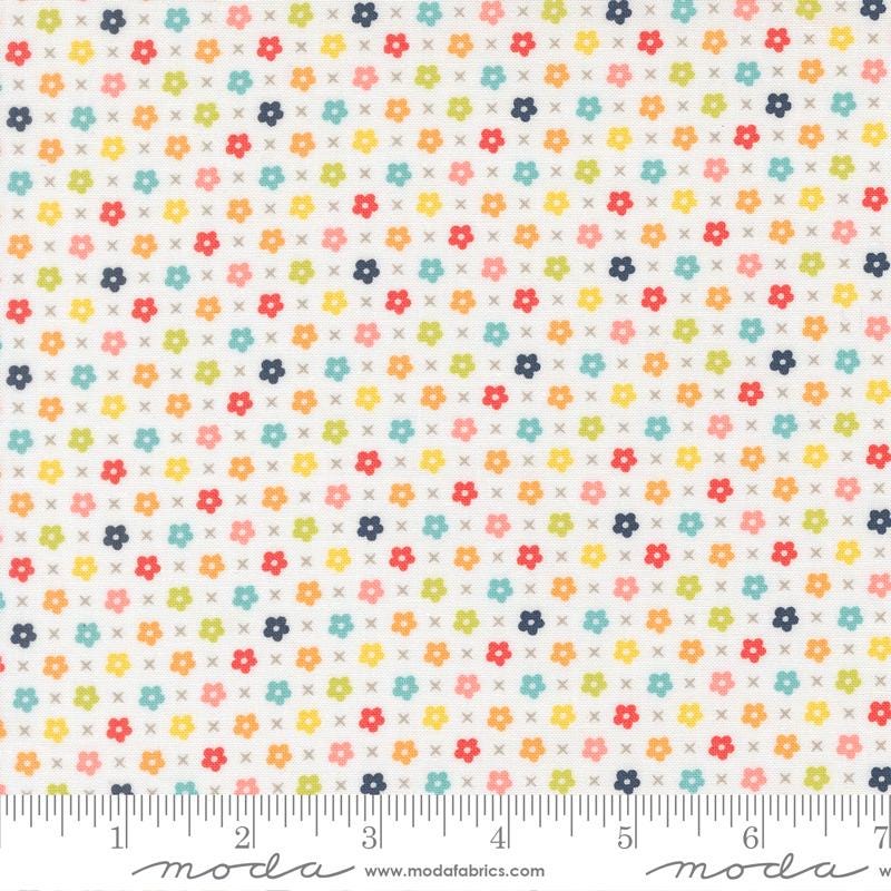 The image is a fabric with a repeating pattern of small flowers in various colors, including red, yellow, green, blue, and orange. The pattern is arranged in a diagonal direction, creating a visually appealing and vibrant design.