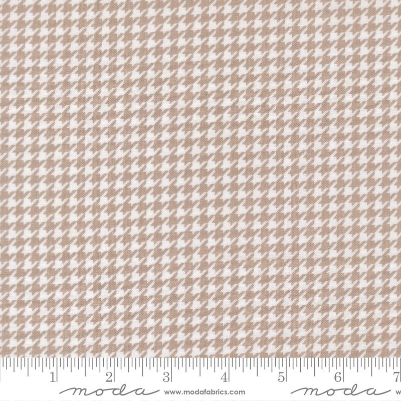 a repeating pattern of brown and white houndstooth designs, creating a visually appealing and intricate pattern.