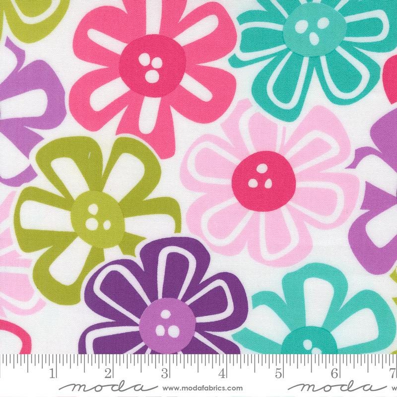 The image is a close-up of a fabric with a repeating pattern of colorful flowers in shades of pink, green, purple, and blue.