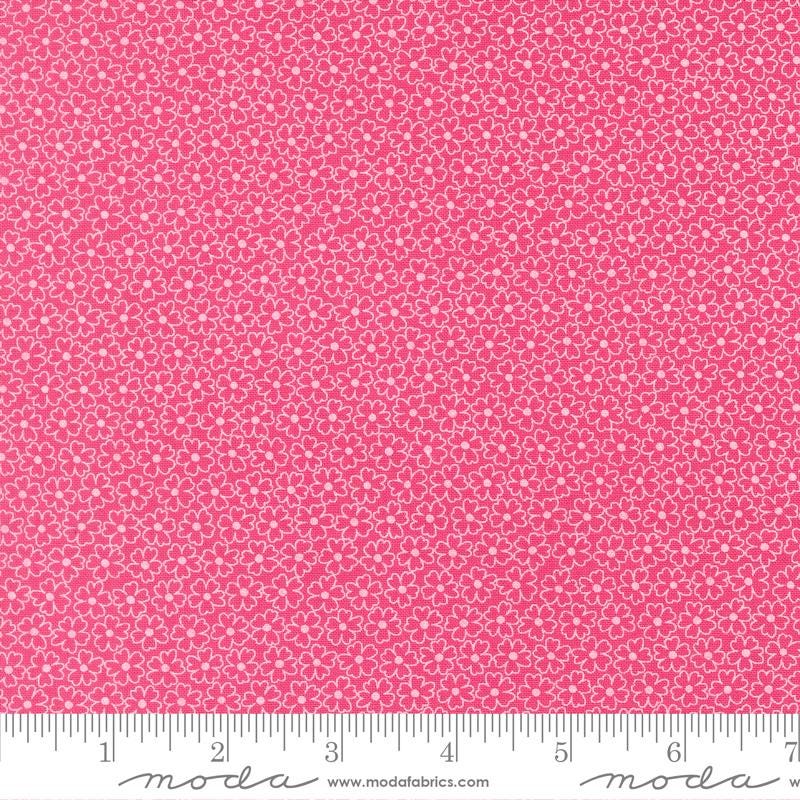 The image is a close-up of a fabric with a pink floral pattern.