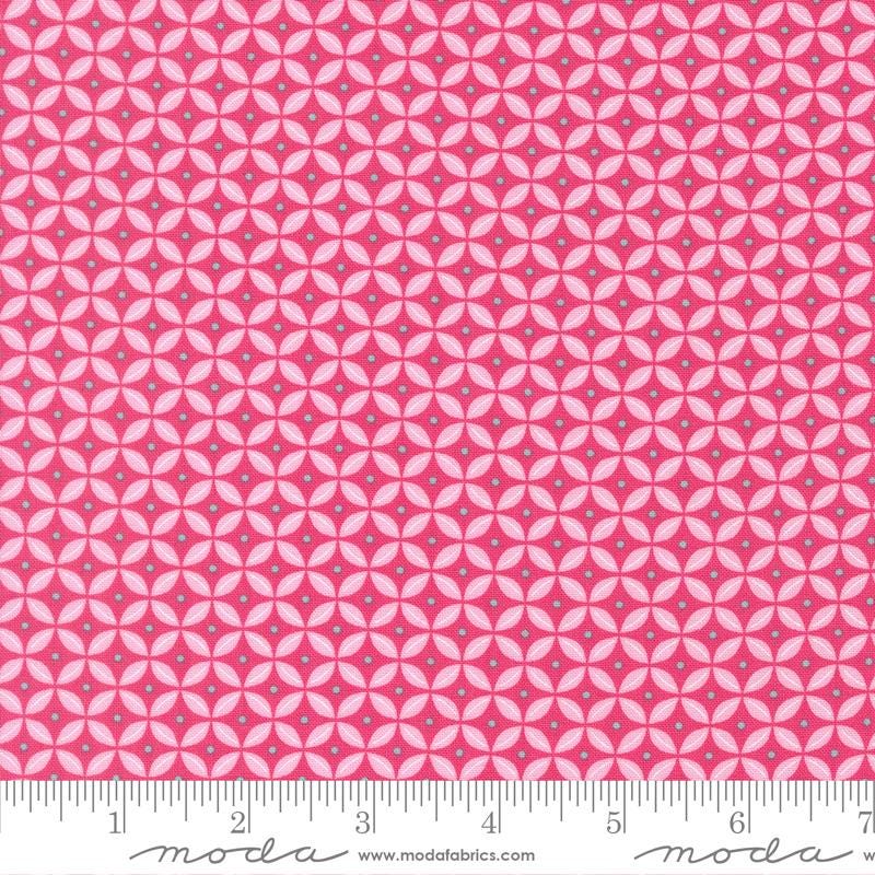 a fabric with a repeating pattern of pink and white circles, creating a visually striking and vibrant design.