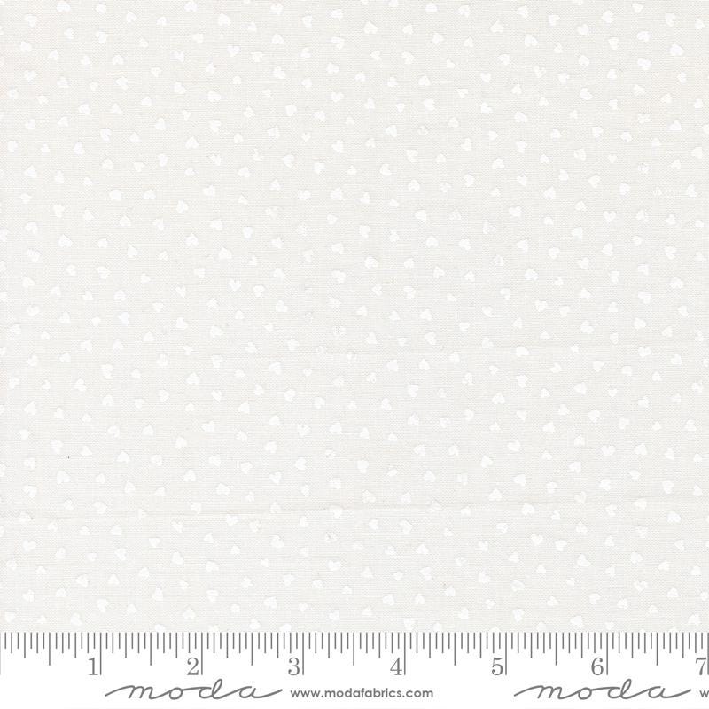 The image is a fabric with a white polka dot pattern.